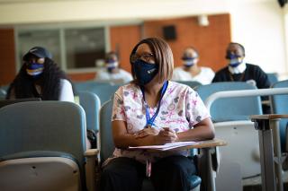 Students in the classroom seated distanced and wearing masks