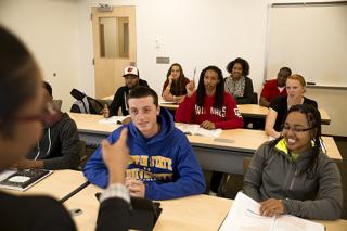 Students in class listening to the teacher