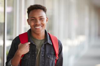 A man wearing a red backpack