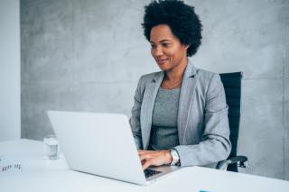 woman sitting in her office and using laptop