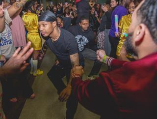 A crowd of students enjoy a performance at midnight breakfast during homecoming at Coppin